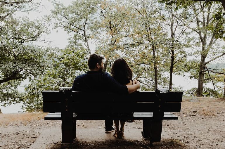 bench-couple-together-arm-around-woman