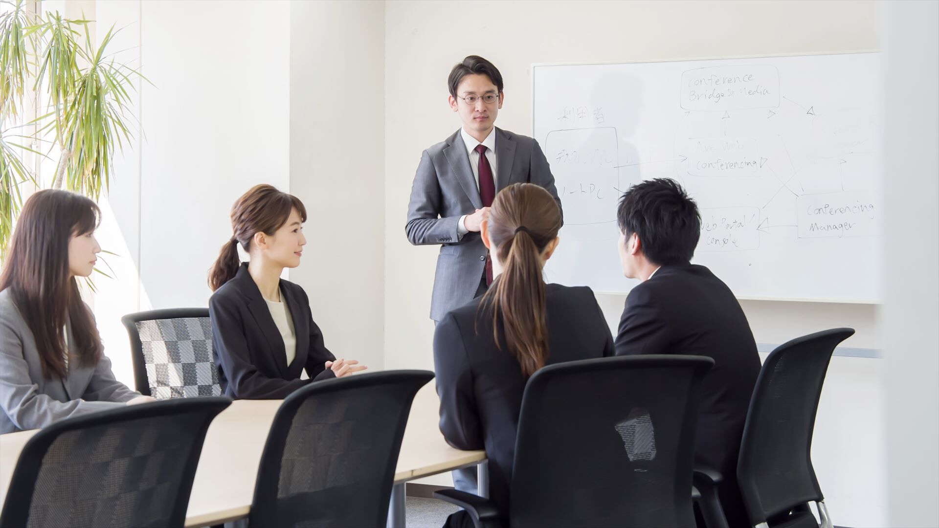 ミーティングで話す男性スタッフ